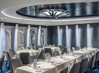 Modern restaurant featuring elegant decor and a circular ceiling | MSC Cruises