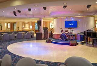 Spacious entertainment area with comfortable seating and warm lighting | MSC Cruises