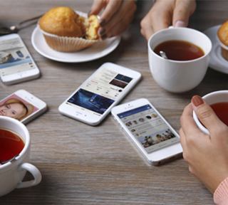 Tea and pastries shared with friends around a table with mobile devices | MSC Cruises