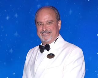 Captain Corrado Iaconis posing in front of a shipboard background | MSC Cruises