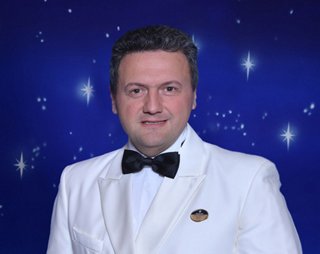 Captain Maresca Lauro smiling in white uniform | MSC Cruises