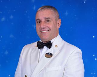 Captain Pietro Sarcinella standing at the bridge control panel | MSC Cruises