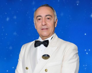 Captain Raffaele Pontecorvo wearing white officer cap and uniform | MSC Cruises