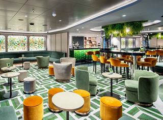 Modern and elegant restaurant setting with colorful tables and chairs | MSC Cruises