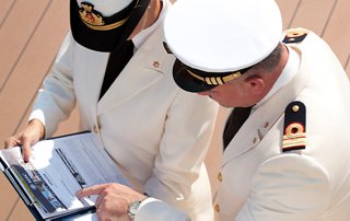 Captain and officer discussing important documents on board a cruise ship | MSC Cruises