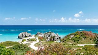 The crystal blue waters of Bermuda surrounded by lush greenery and white buildings | MSC Cruises