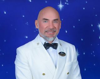 Crew officer in formal uniform smiling for a portrait | MSC Cruises
