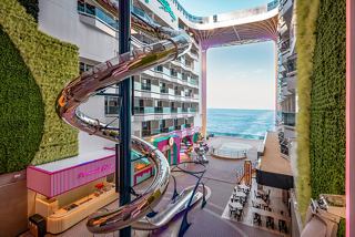 A cozy relaxation area with a sea view and vibrant accents | MSC Cruises