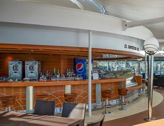 Modern dining area with cozy decor and a bar on a cruise ship | MSC Cruises