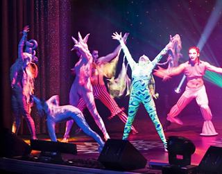 Dancers perform an inspiring show on stage in vibrant costumes | MSC Cruises
