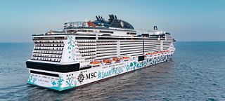 A large cruise ship sailing on calm waters under a clear sky | MSC Cruises