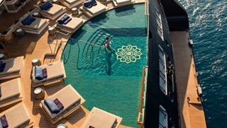The pool area features clear water and comfortable loungers for relaxation | MSC Cruises