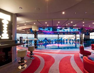 A vibrant lounge with comfortable seating and a stunning view, perfect for relaxation and entertainment | MSC Cruises