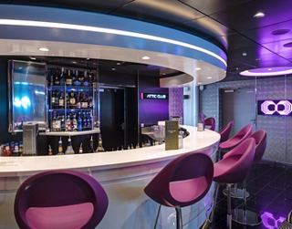 A vibrant bar area with stylish seating, inviting guests to enjoy drinks and socialise together | MSC Cruises