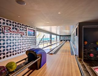 A vibrant bowling alley with polished lanes and colourful bowling balls ready for an exciting game | MSC Cruises