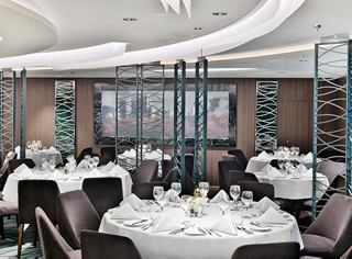 Modern restaurant featuring elegant tables and a cozy atmosphere for unforgettable dining experiences | MSC Cruises