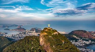 A panoramic view of Christ the Redeemer statue overlooking the sea and Rio de Janeiro in Brazil | MSC Cruises