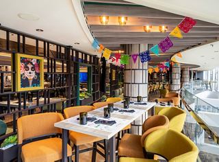 Modern restaurant setting with comfortable tables and colorful decorations | MSC Cruises