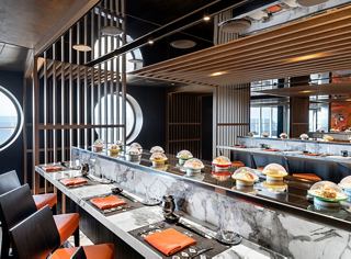 Modern dining area with bright green accents and cozy seating options | MSC Cruises