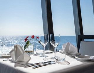 Table set with flowers, offering a stunning ocean view | MSC Cruises