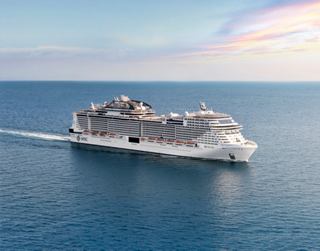 A majestic cruise ship gliding through serene waters under a beautiful sky | MSC Croisières