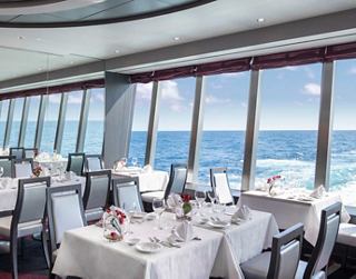 The bright restaurant with a sea view offers a cozy atmosphere and stylish tables | MSC Cruises