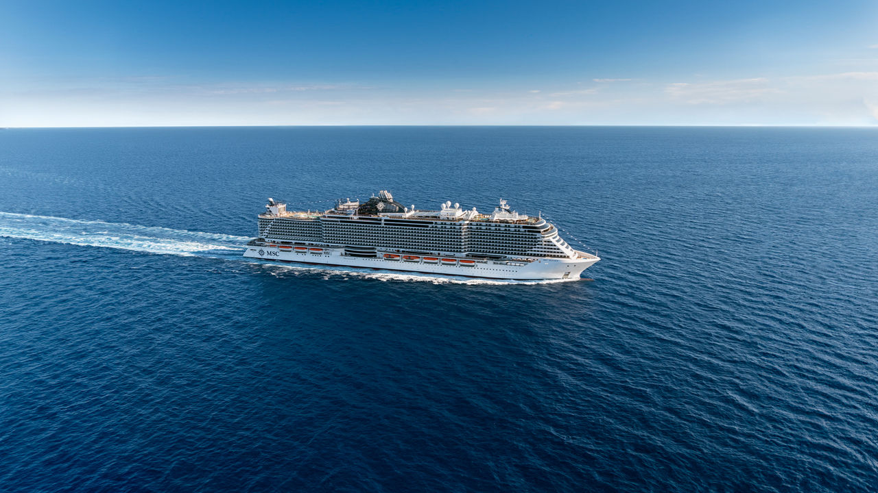Un majestueux paquebot navigue à travers les eaux calmes de l'océan bleu, révélant la beauté de l'aventure maritime | MSC Cruises