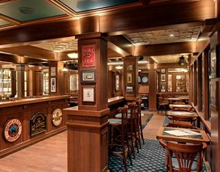 An inviting bar area featuring warm wood tones and a comfortable atmosphere for relaxation and socialising | MSC Cruises