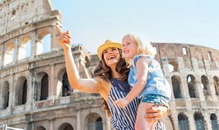 A mother and child share a joyful moment at the Colosseum in Rome | MSC Cruises