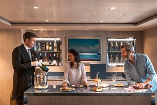 A couple enjoys attentive butler service and refined ambiance in the MSC Yacht Club | MSC Cruises