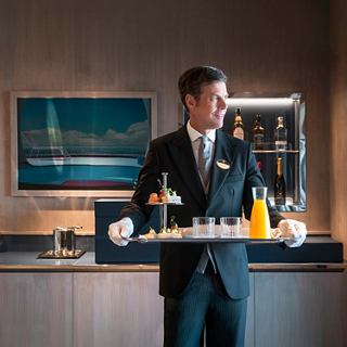 MSC Yacht Club butler serves a fresh juice in the Owner's Suite on board | MSC Cruises