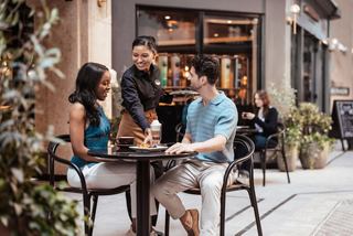 Guests enjoy coffee and conversation in a stylish onboard café setting | MSC Cruises