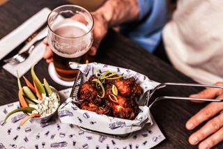 Tasty appetizers and a drink served at a table in a welcoming setting | MSC Cruises