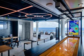 Contemporary sports bar featuring sea views and inviting seating areas | MSC Cruises