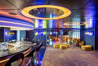 Vibrant lighting and inviting seating create a lively setting in the Attic Club | MSC Cruises