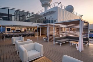 The Aurea Bar on MSC Seashore welcomes guests with inviting lounge seating and a sun deck | MSC Cruises