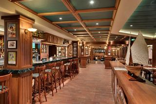 Brass Anchor Pub features a welcoming setting with wooden seating and a spacious bar counter | MSC Cruises