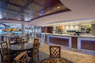 Buffet bar on cruise ship with tables, chairs and fruit for guests to enjoy | MSC Cruises