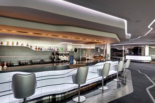 Modern bar and lounge area with stylish seating on MSC Grandiosa | MSC Cruises