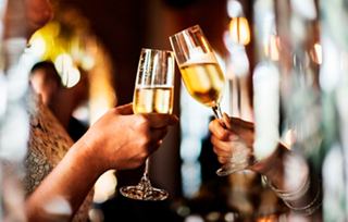 Guests raise champagne glasses for a toast in the inviting bar on MSC Seaside | MSC Cruises