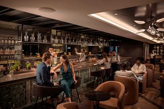 Guests share drinks at the Elixir Mixology Bar enjoying a welcoming ambiance on board | MSC Cruises