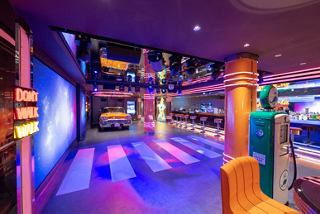 Garage Club featuring a dance floor, bar and car-themed decorations for entertainment | MSC Cruises