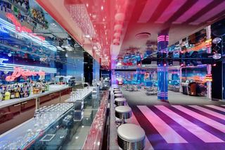 Vibrant bar and club with modern lighting and colorful interior accents | MSC Cruises