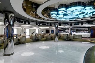Contemporary lounge featuring spacious seating, a dance floor and a stylish bar counter | MSC Cruises