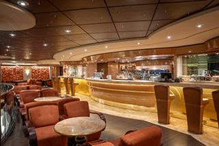 Inviting lounge area with comfortable seating and a stylish bar on the ship | MSC Cruises