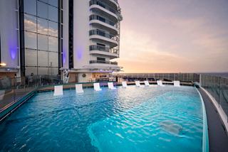 Infinity pool overlooking the sea with inviting sunbeds aboard MSC Seascape | MSC Cruises