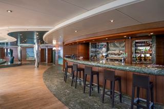Bar with inviting stools and a relaxing atmosphere beside the indoor pool on MSC Splendida | MSC Cruises