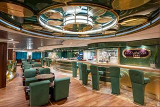 L'Espresso features green seating and a welcoming bar area with warm lighting | MSC Cruises