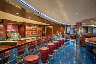 Bar and lounge area on MSC Divina featuring comfortable seating and a stylish bar counter | MSC Cruises