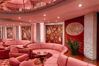 Inviting lounge with pink sofas and a green plant on MSC Magnifica | MSC Cruises